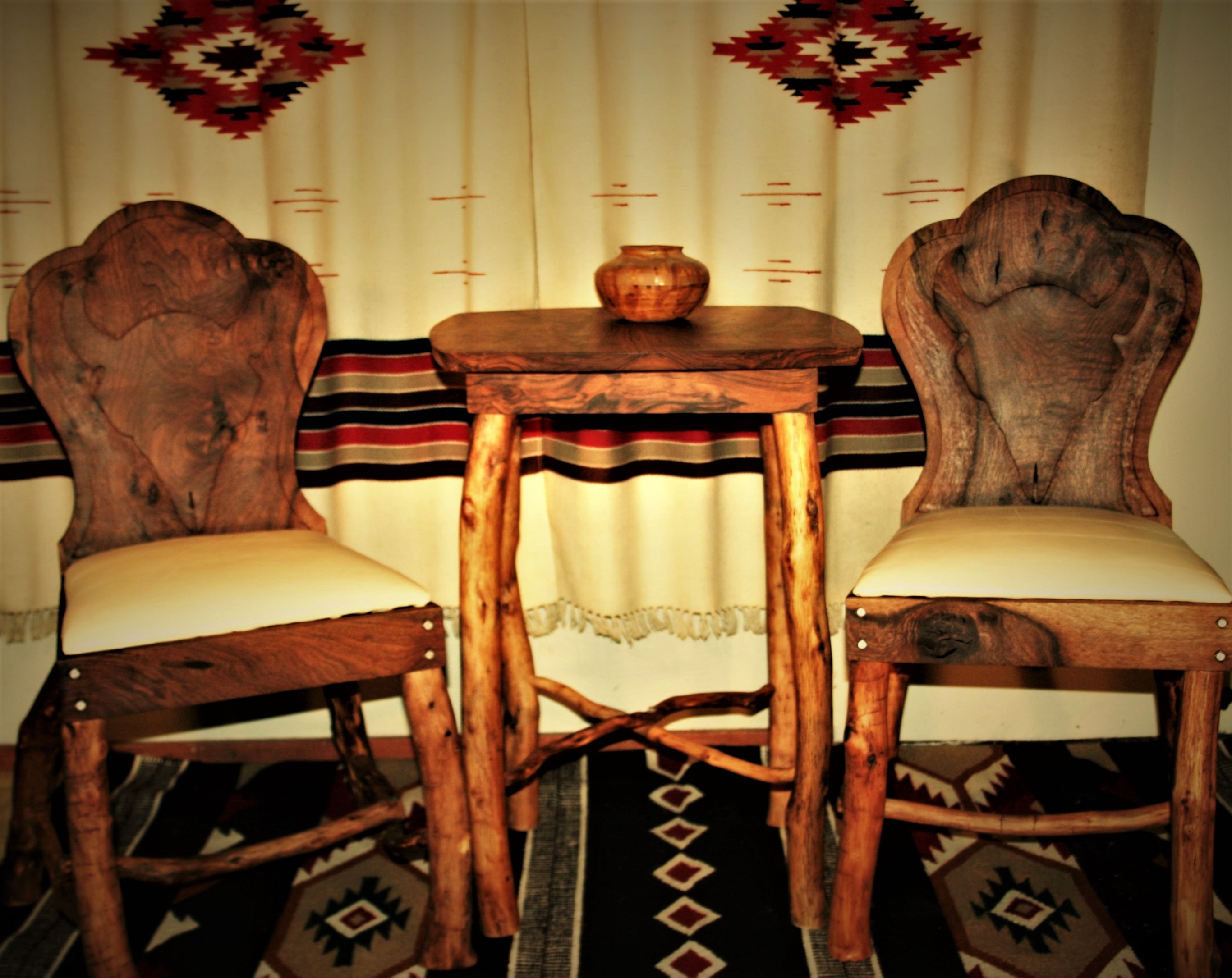 Claro walnut side table and keyhole chairs with hand routed bison skull backs, oak legs