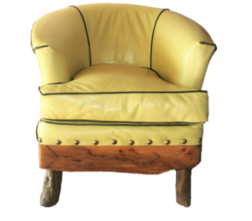 yellow leather, black welt tub chair with hand routed pronghorns on live edge oak panel